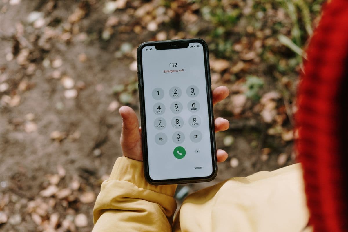 A homeowner dialling another plumber on a smartphone during an emergency